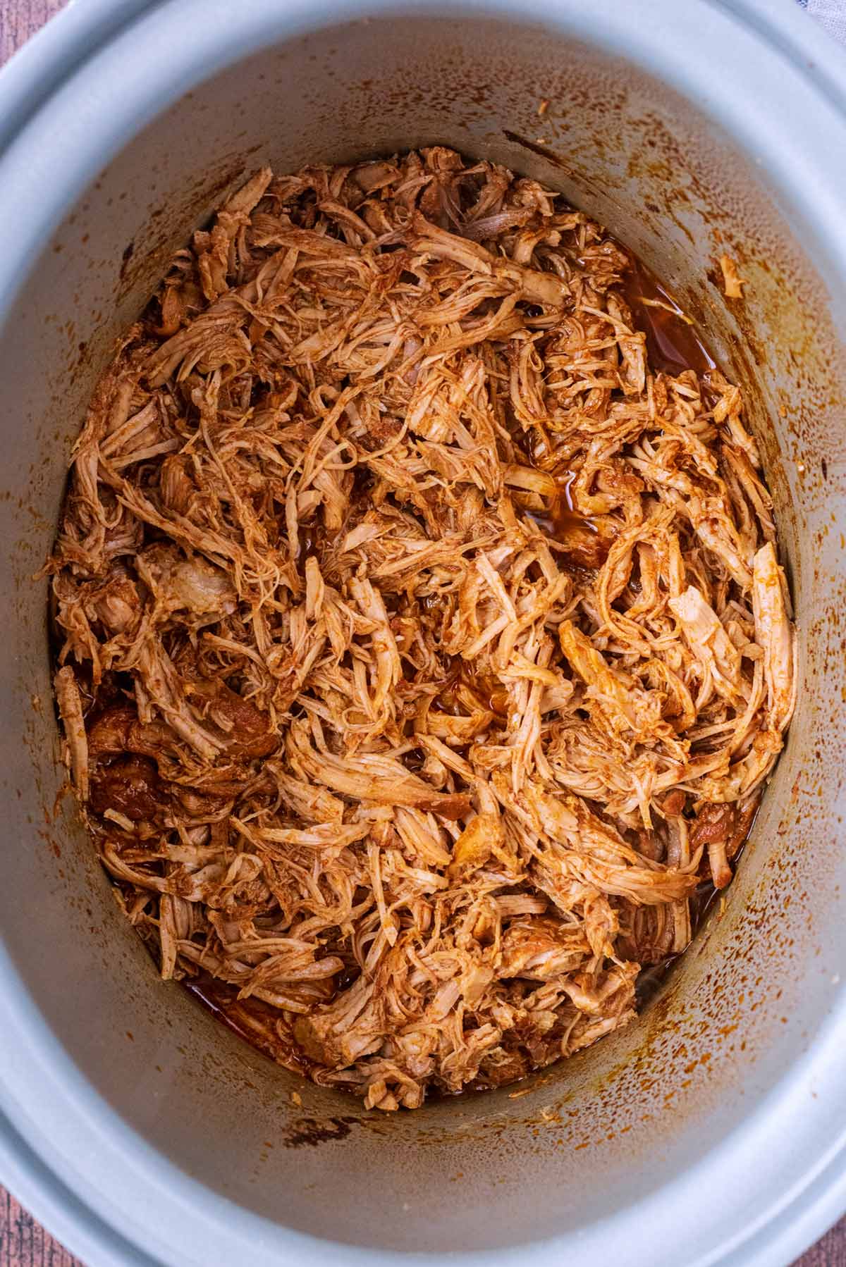 Pulled pork in a slow cooker bowl.