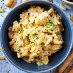 Slow cooker mac and cheese in a blue bowl.