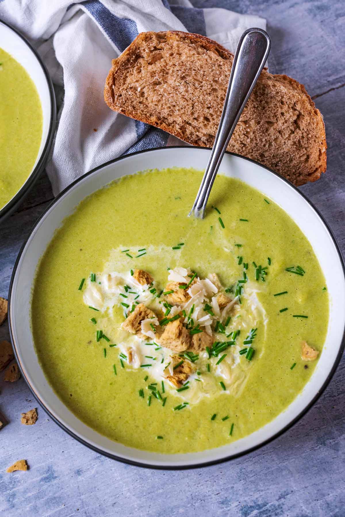 Asparagus soup in a bowl with a spoon.