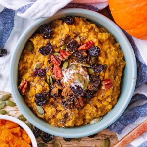 Pumpkin porridge topped with yogurt, fruit and chopped pecans.