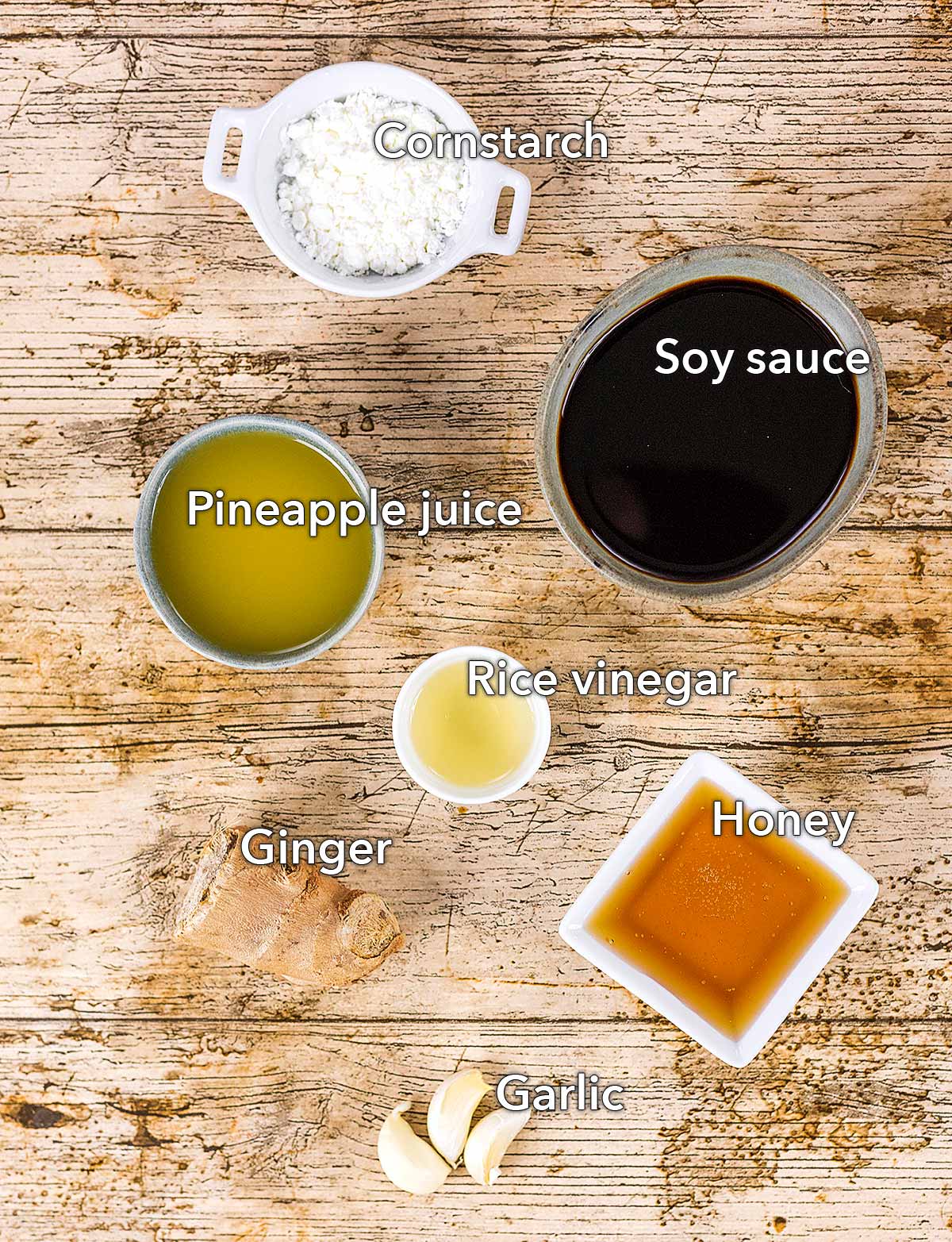 The ingredients for homemade teriyaki sauce laid out on a wooden surface.