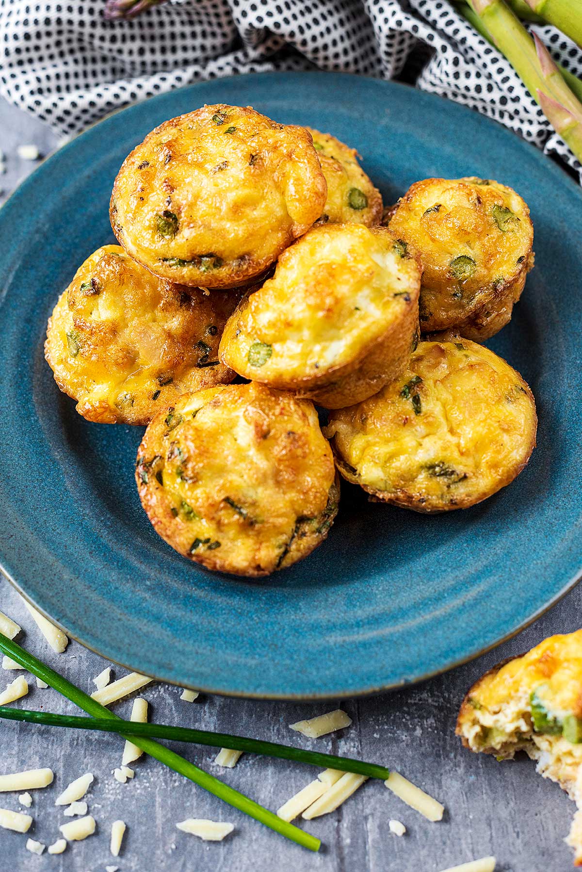 Salmon egg muffins piled up on a blue plate.
