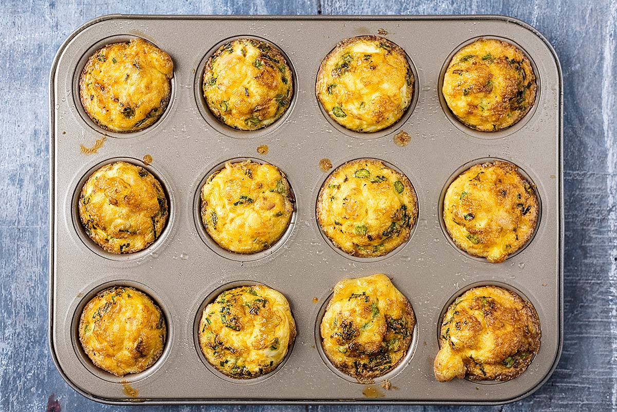 Cooked egg muffins in a muffin tin.