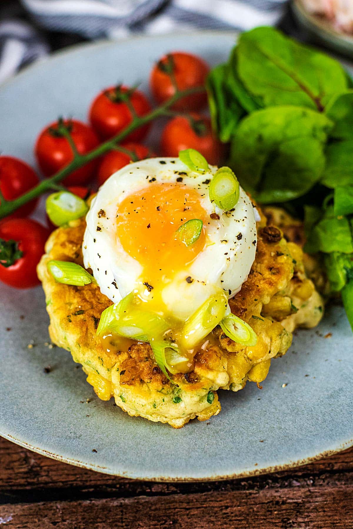 A sweetcorn fritter topped with a poached egg.