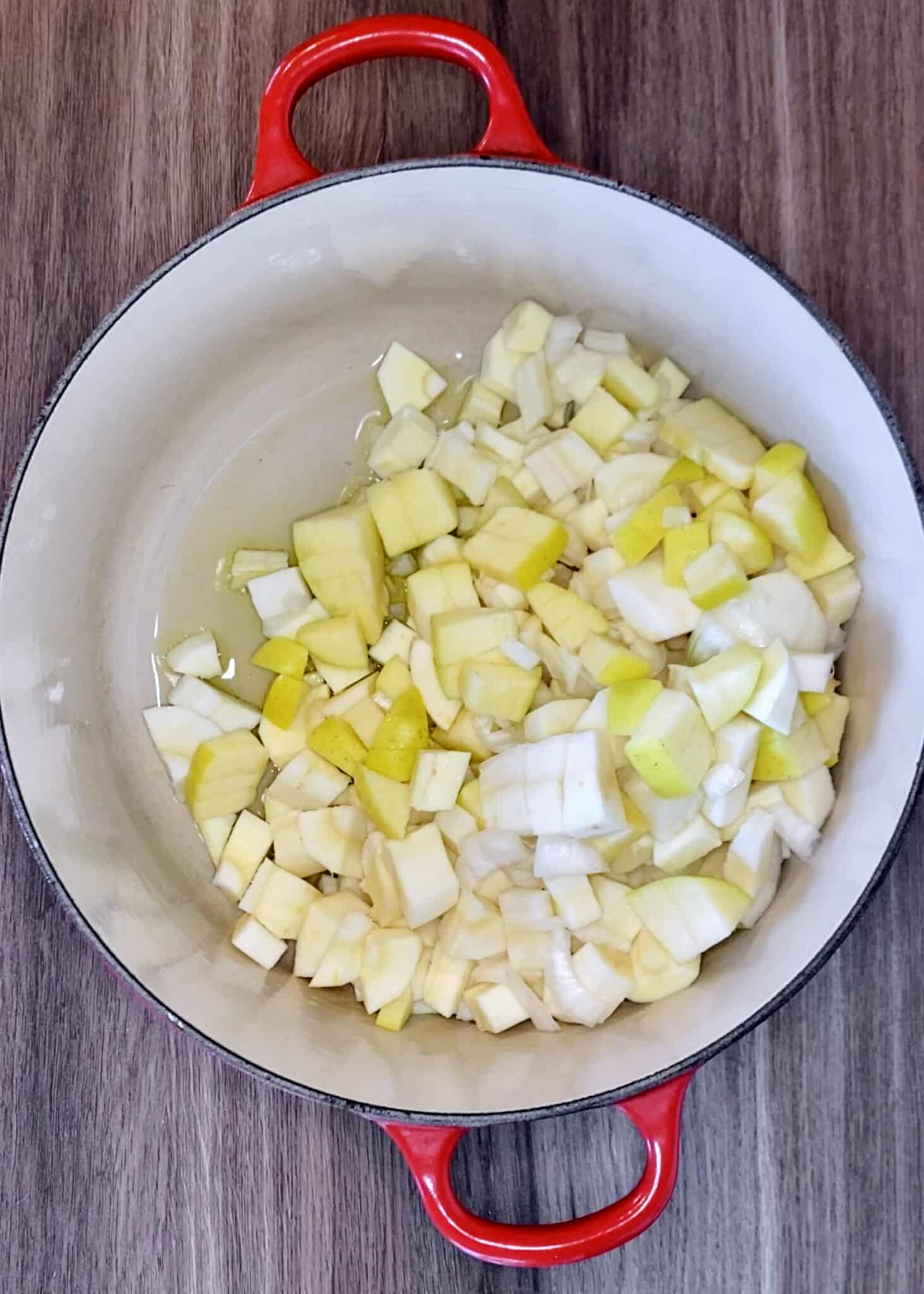 Chopped parsnip, shallots and apple in a large pan.