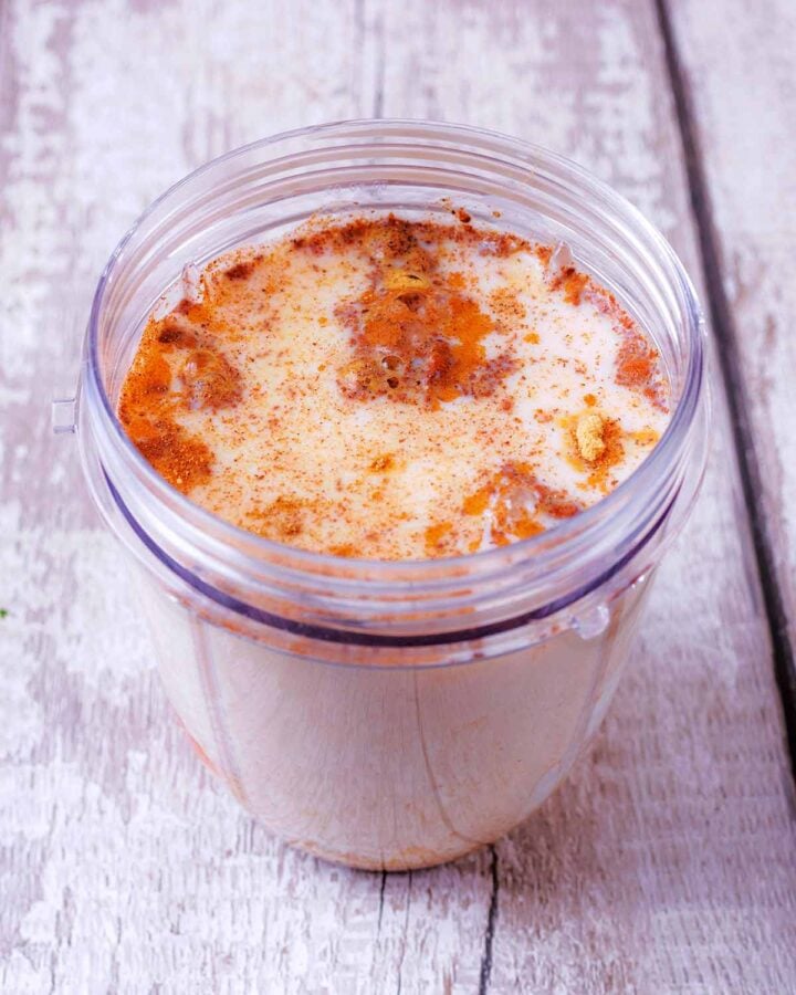 The blender jug topped up with milk.