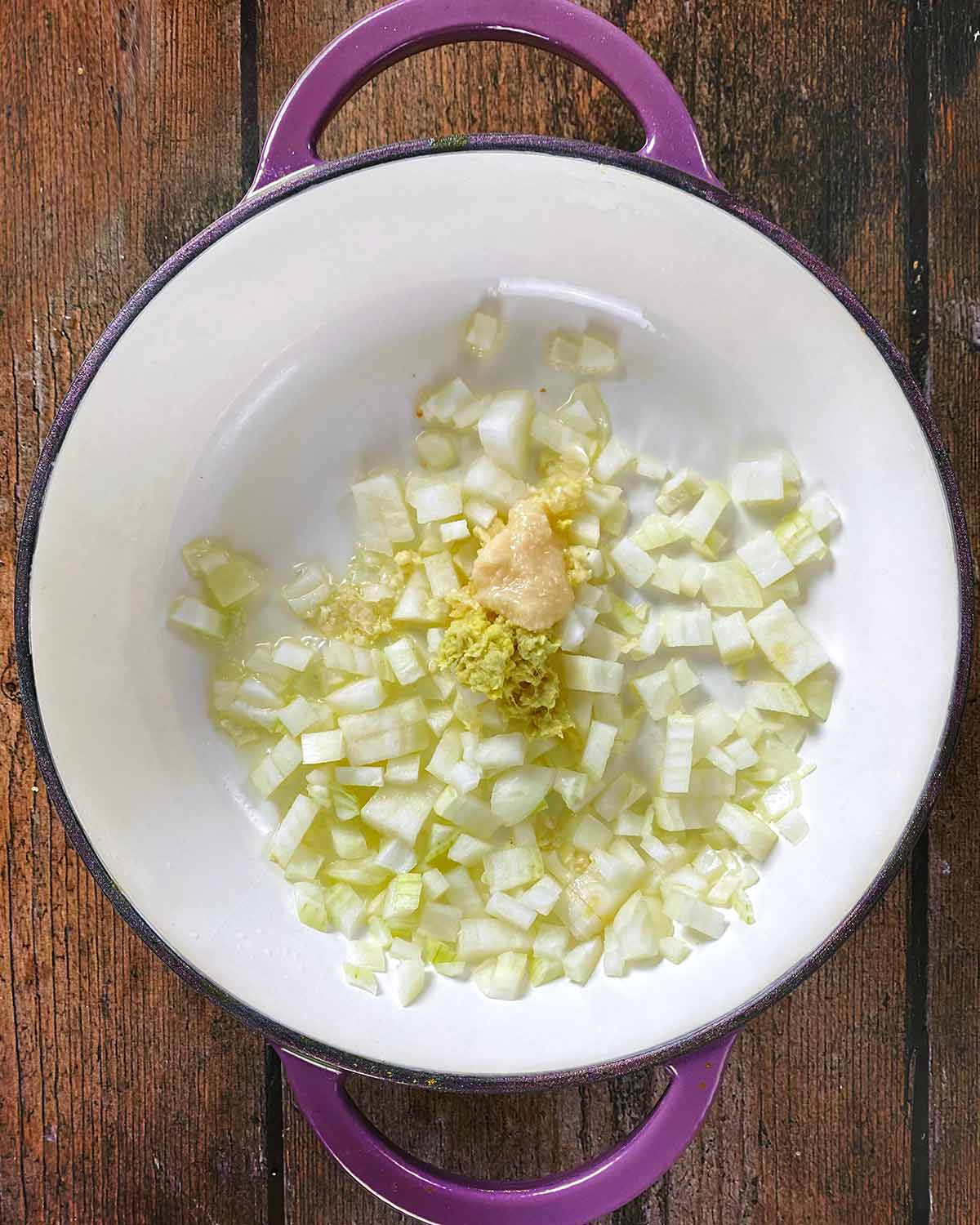 Chopped onion, crushed garlic and grated ginger saut&eacute;ing in a large pan.
