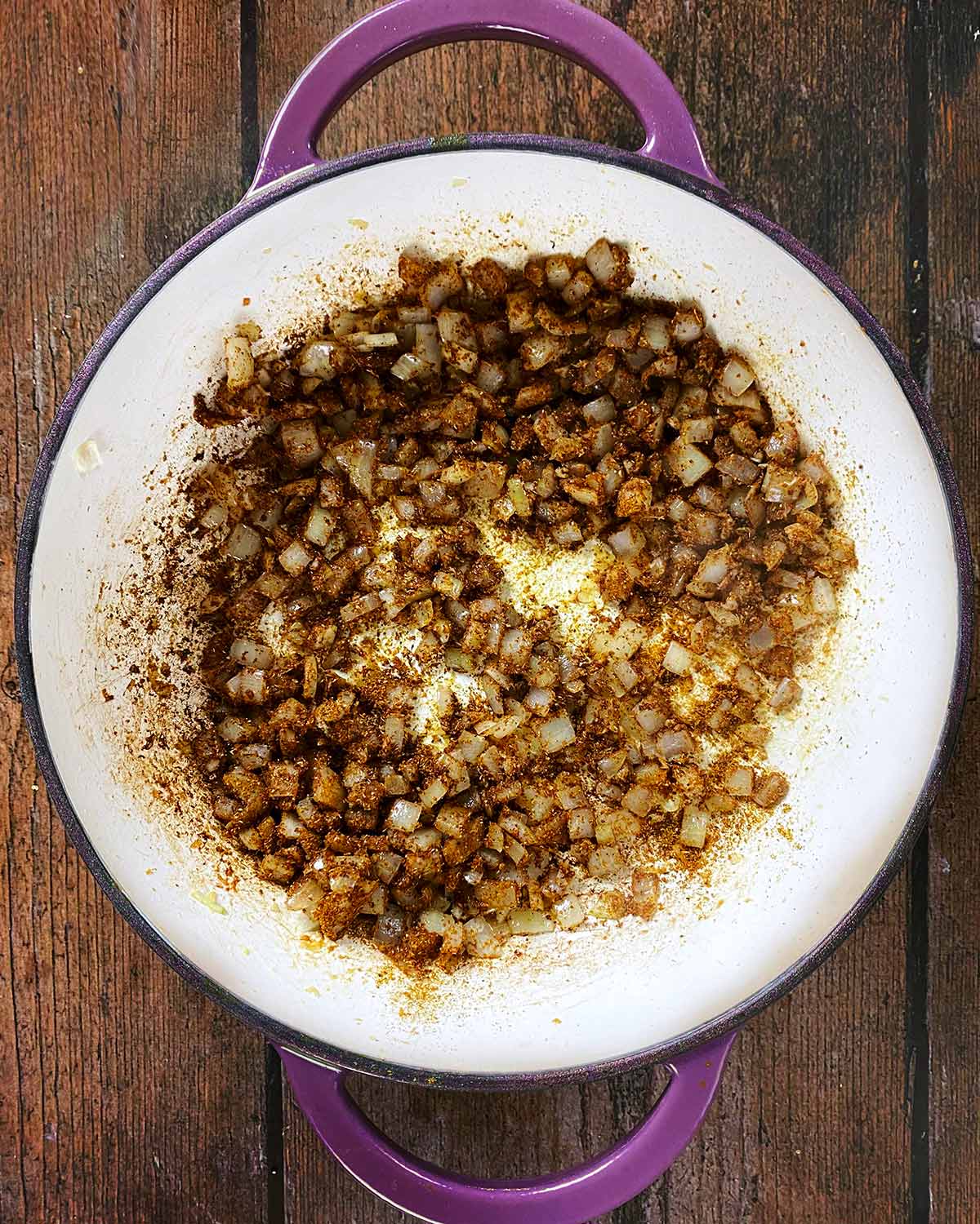 Curry powder has been added to the pan and mixed in.