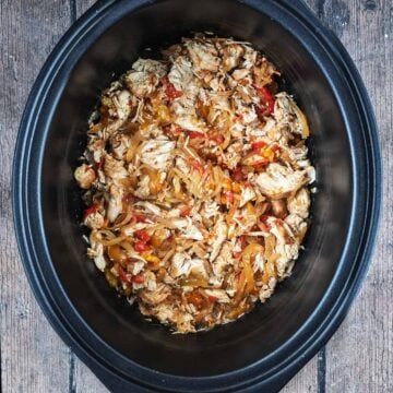 Slow cooker chicken fajitas in a slow cooker bowl.