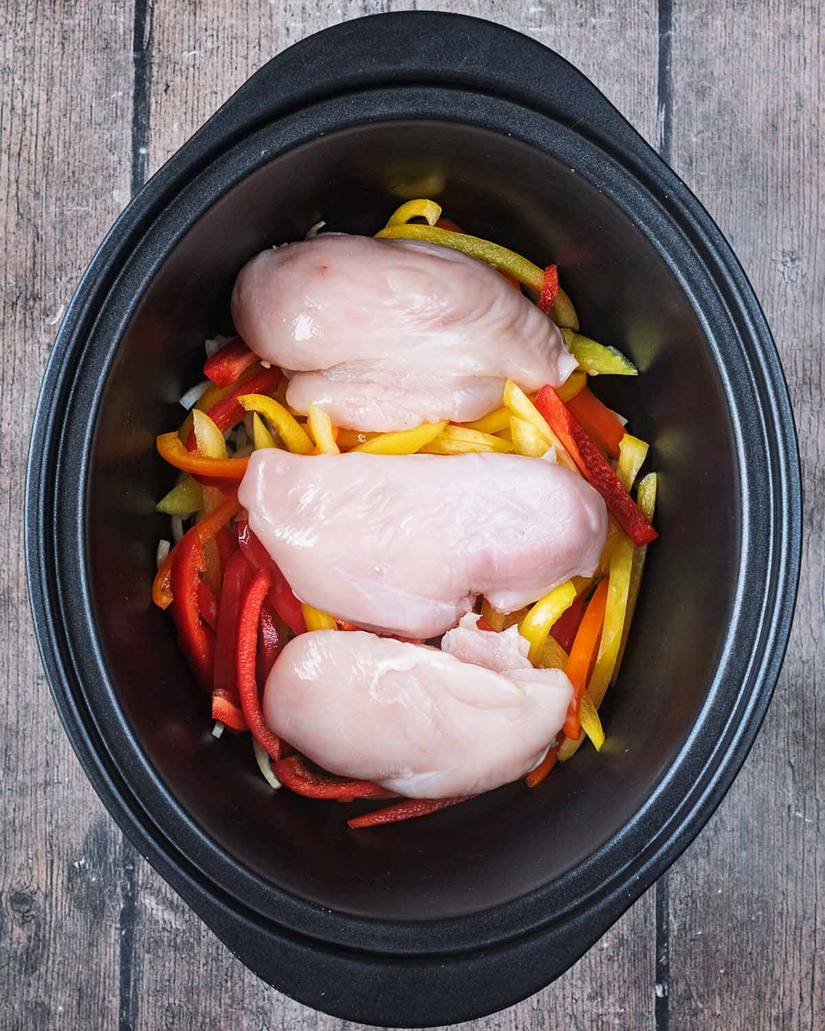 Three chicken breasts added to the the slow cooker.