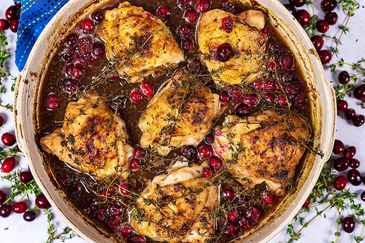 Cooked chicken and cranberries in a sauce.