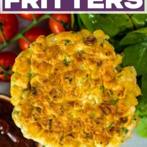 A sweetcorn fritter next to wome tomatoes and spinach with a title text overlay.