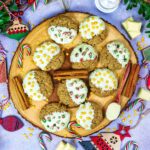 Healthy Christmas Cookies on a wooden serving board surrounded by festive decorations.