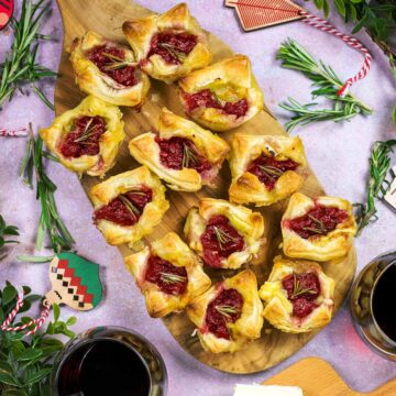 Cranberry and Brie Bites on a wooden serving board.