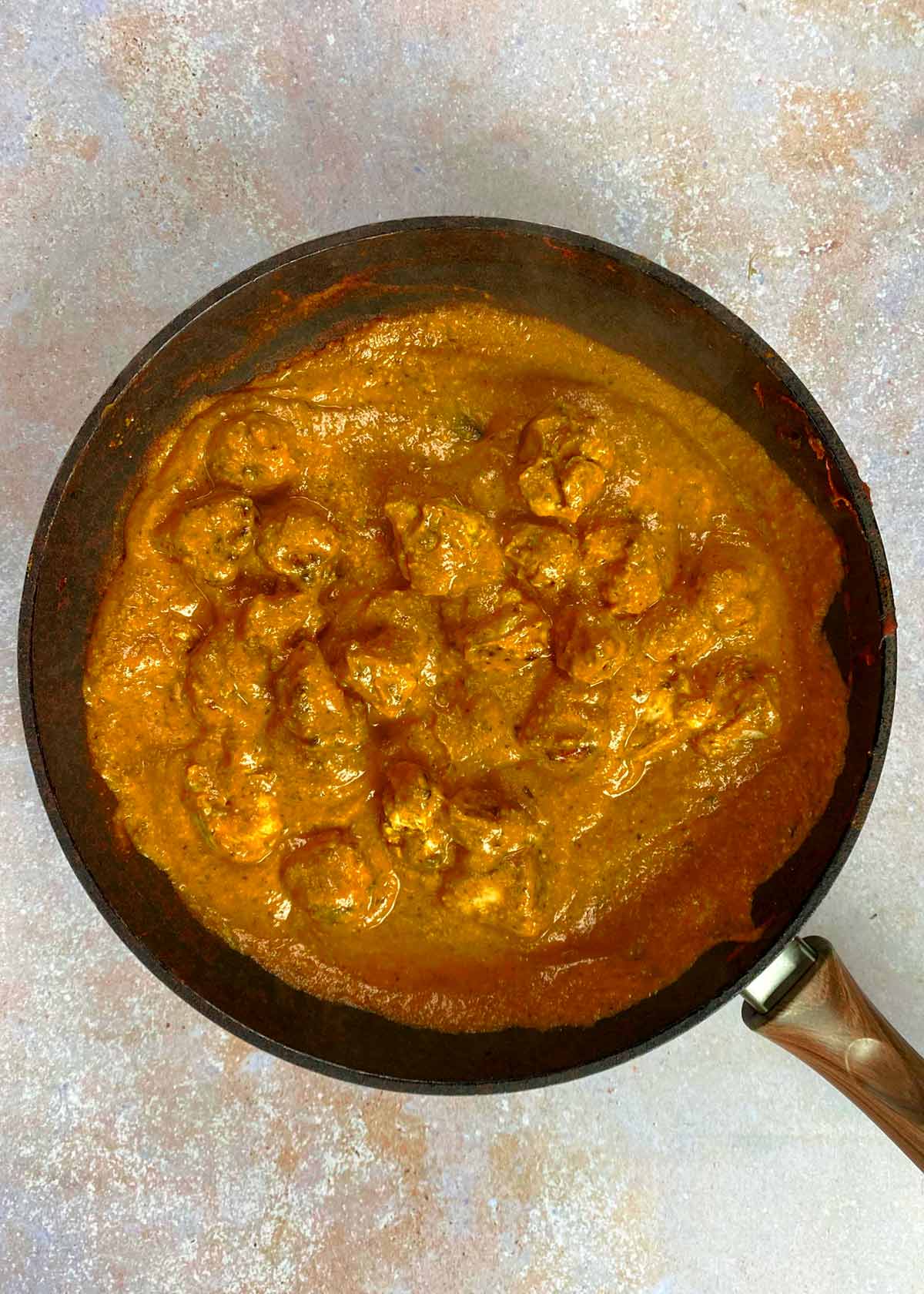 Chicken chunks added to the curry sauce.