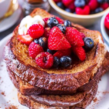 Four slices of healthy French toast with berries on top.