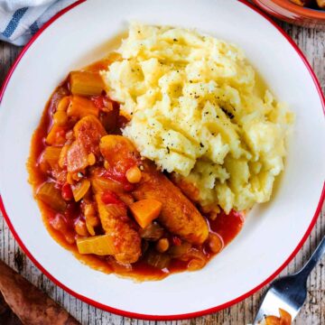 A plate of slow cooker sausage casserole and mashed potato