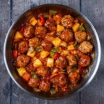 A pan full of sweet and sour chicken meatballs.