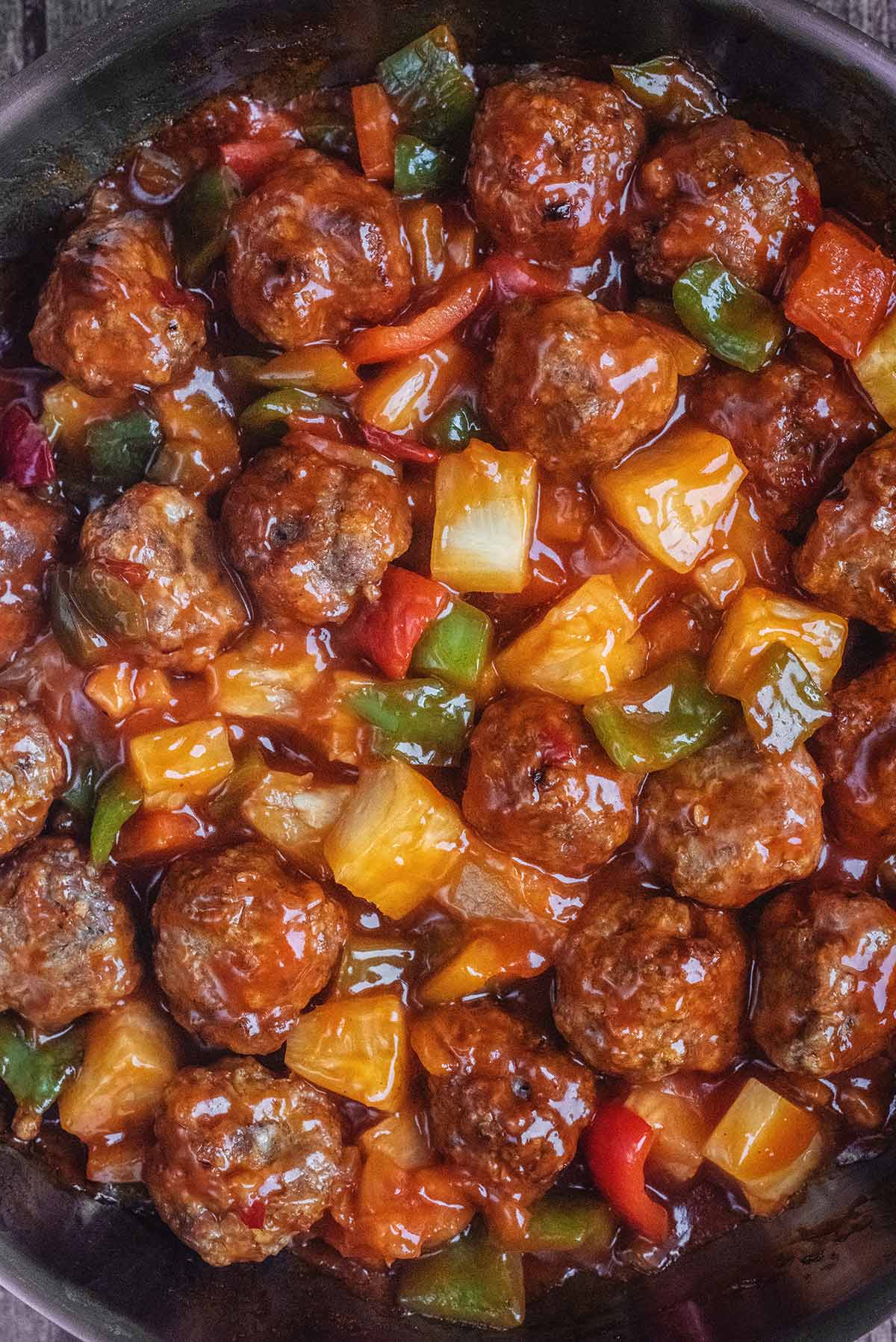 Cooked meatballs in a sweet and sour sauce.