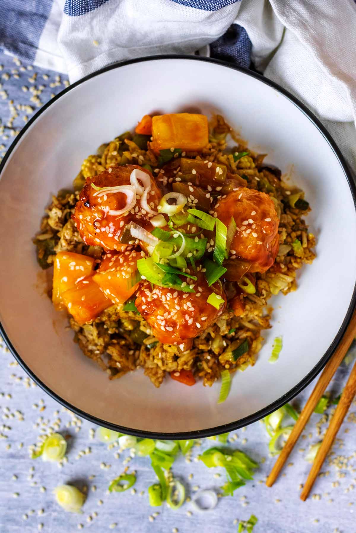 A bowl of meatballs and fried rice.