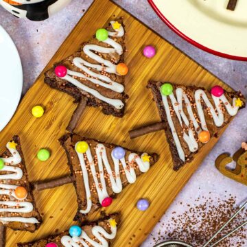 Five Christmas Tree Brownies on a wooden board.