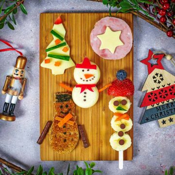 Kid's Christmas Snacks on a wooden serving board.