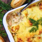 Salmon Casserole in a baking tin with a spoon removing a portion.