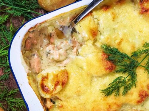 Salmon Casserole in a baking tin with a spoon removing a portion.