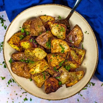 Air fryer roast potatoes in a round bowl.