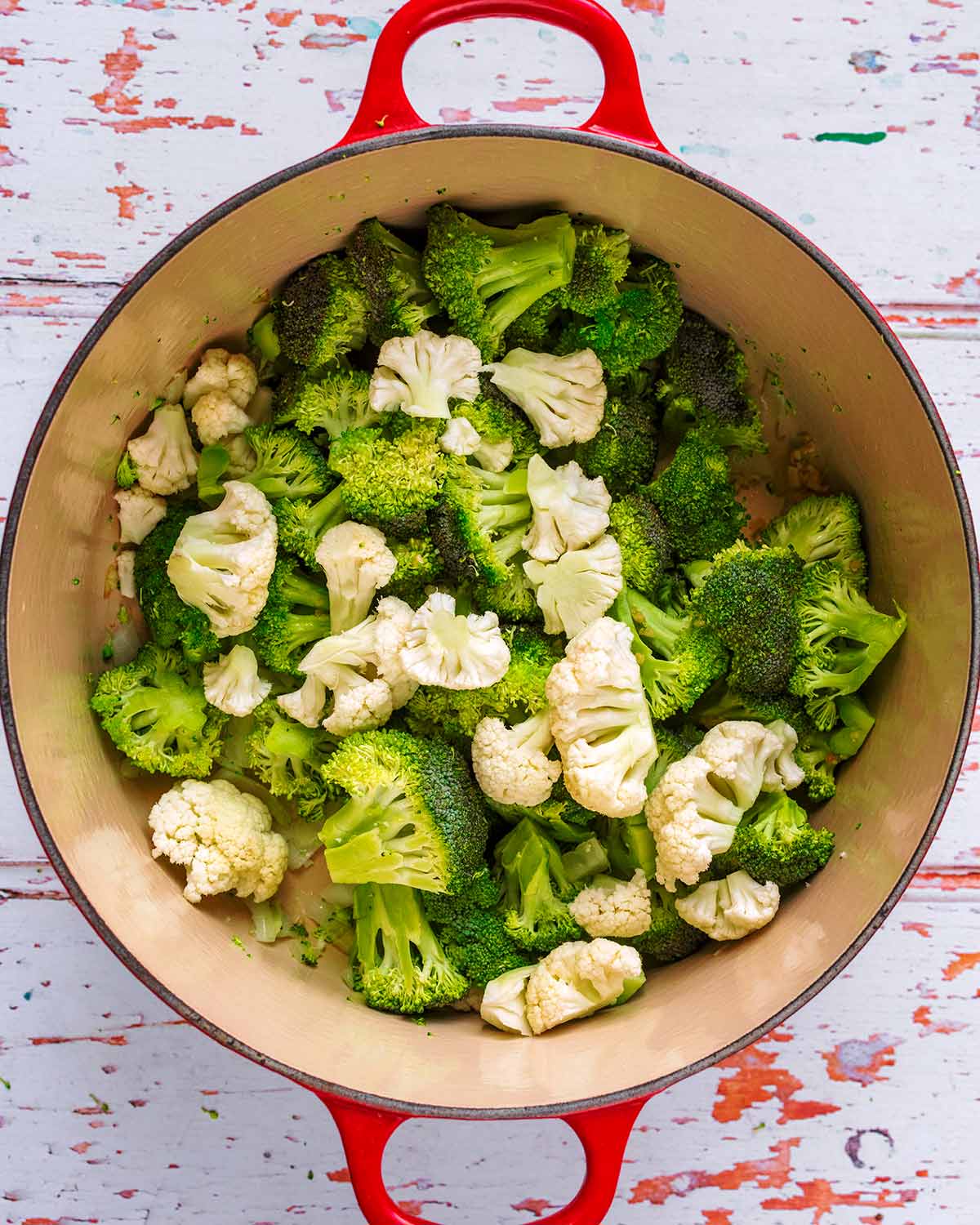 Broccoli and cauliflower florets added to the pan.