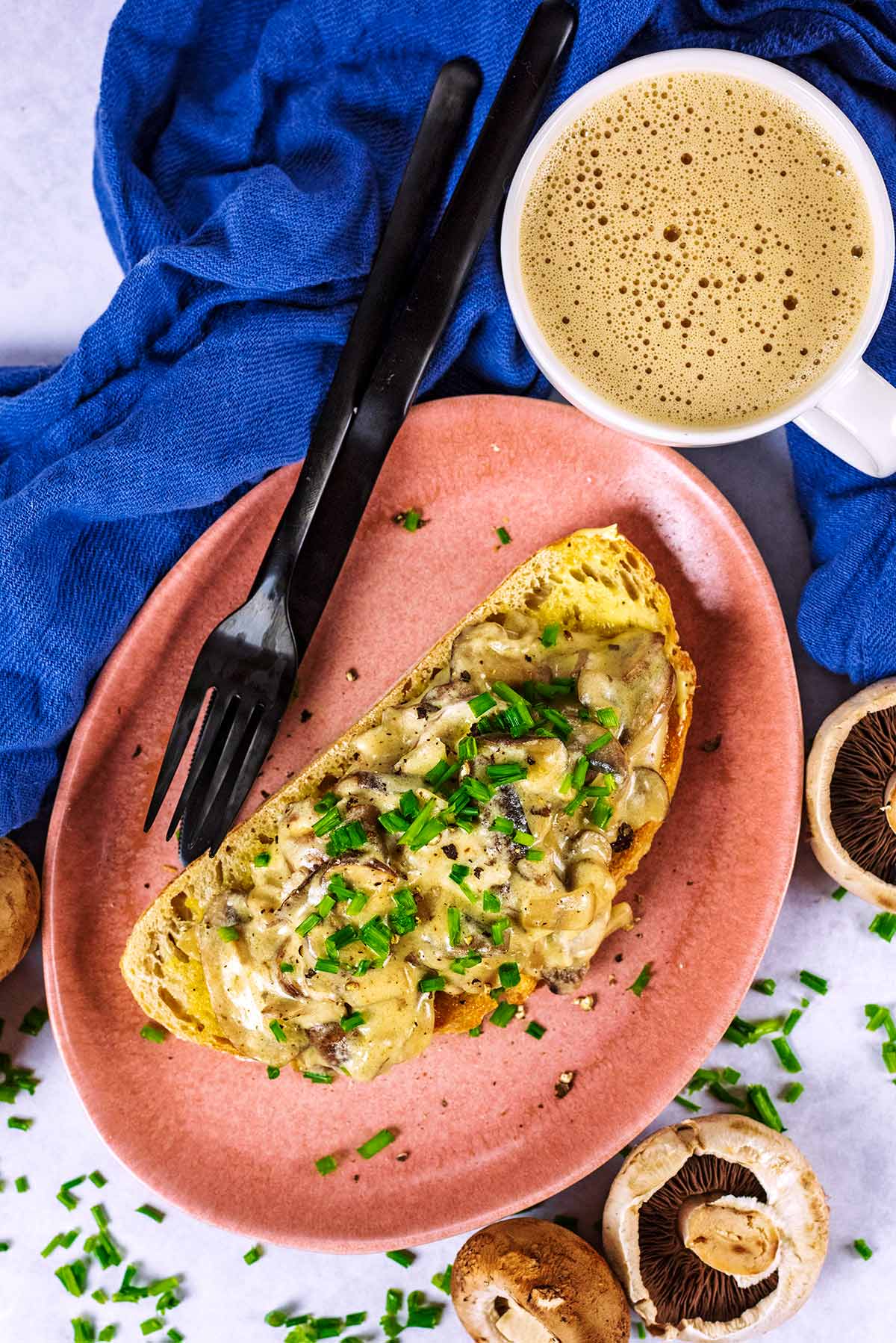 A slice of toast topped with creamy mushrooms.