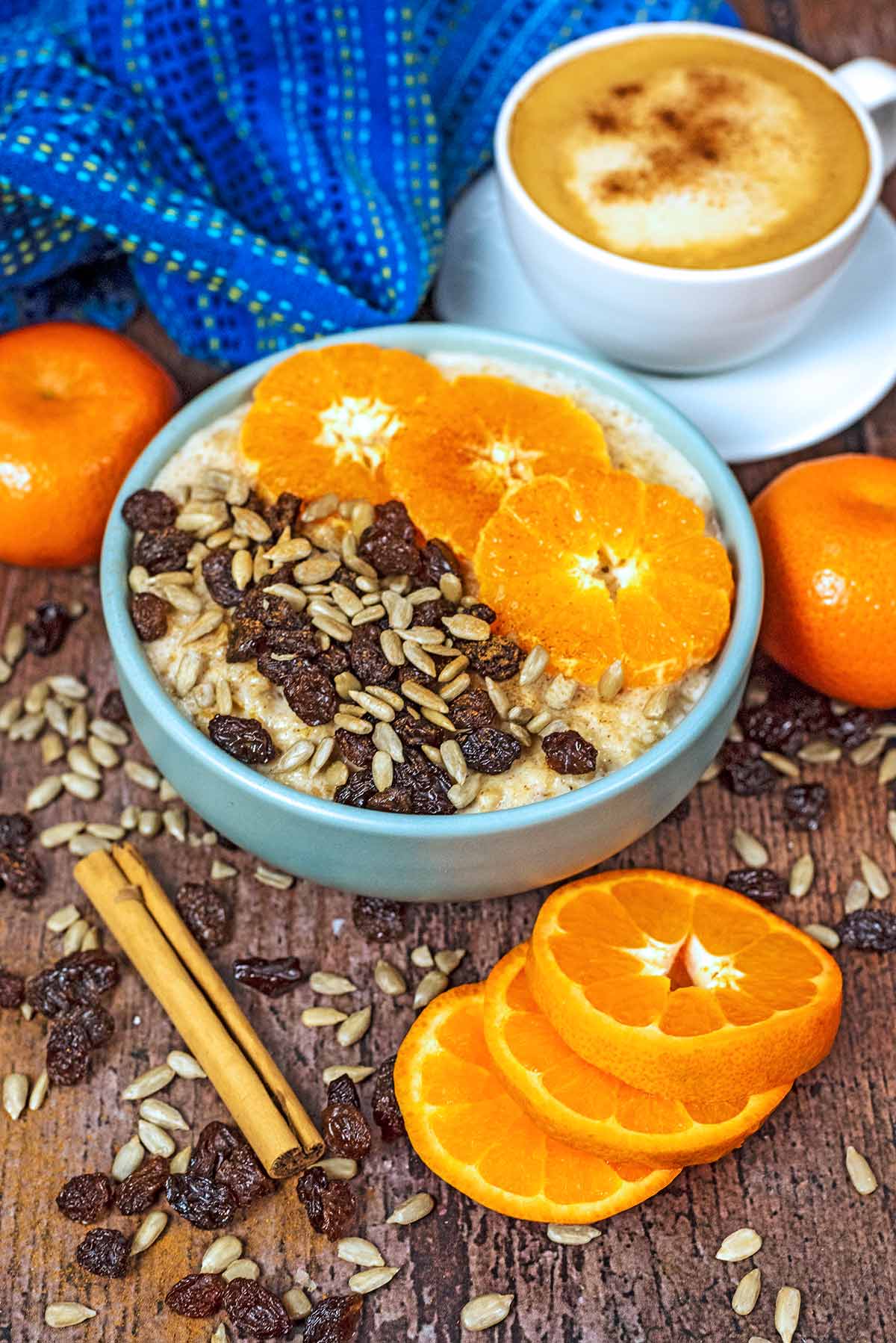 A bowl of oats topped with orange spices in front of a blue towel.