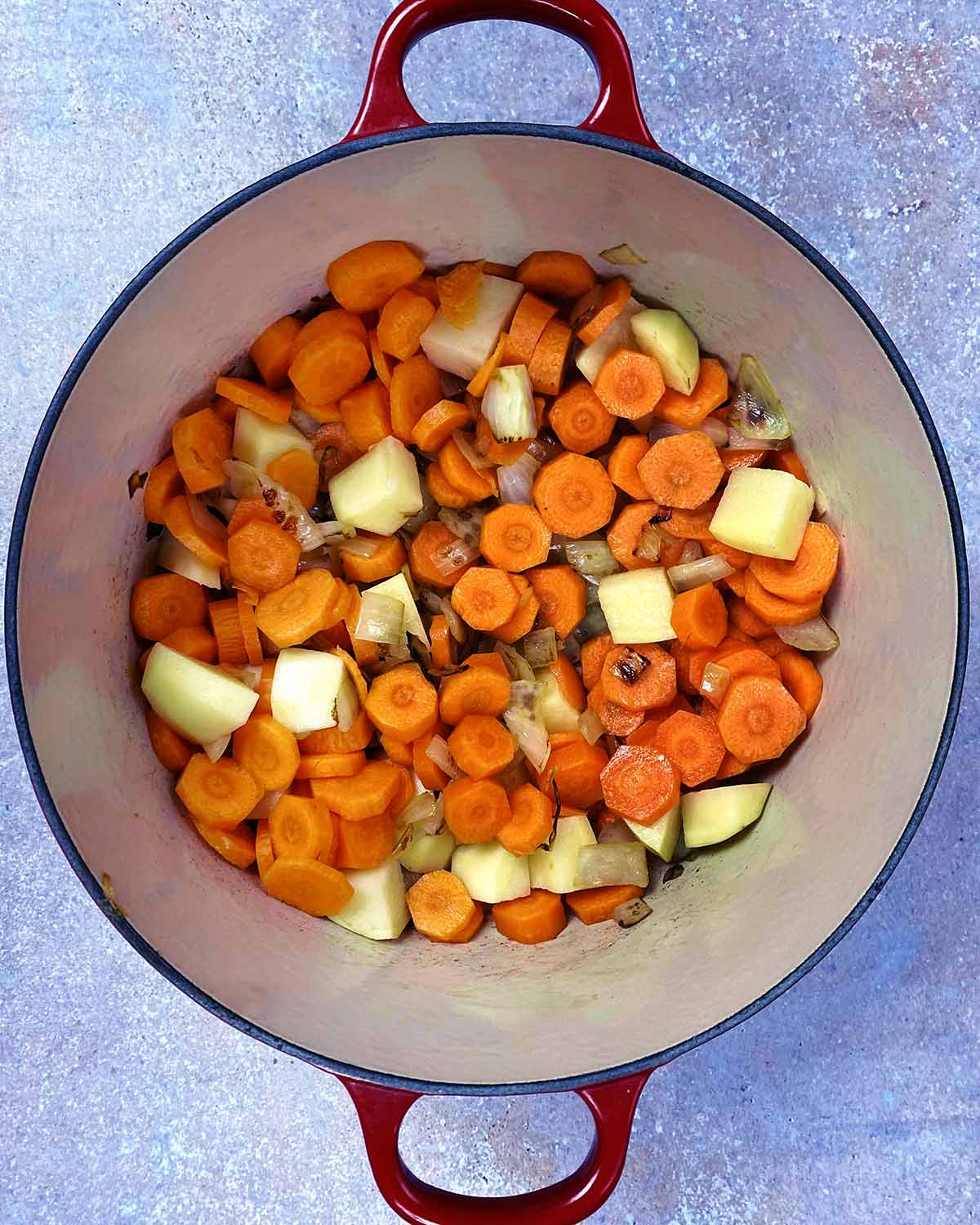 Chopped carrots and potato added to the pan.