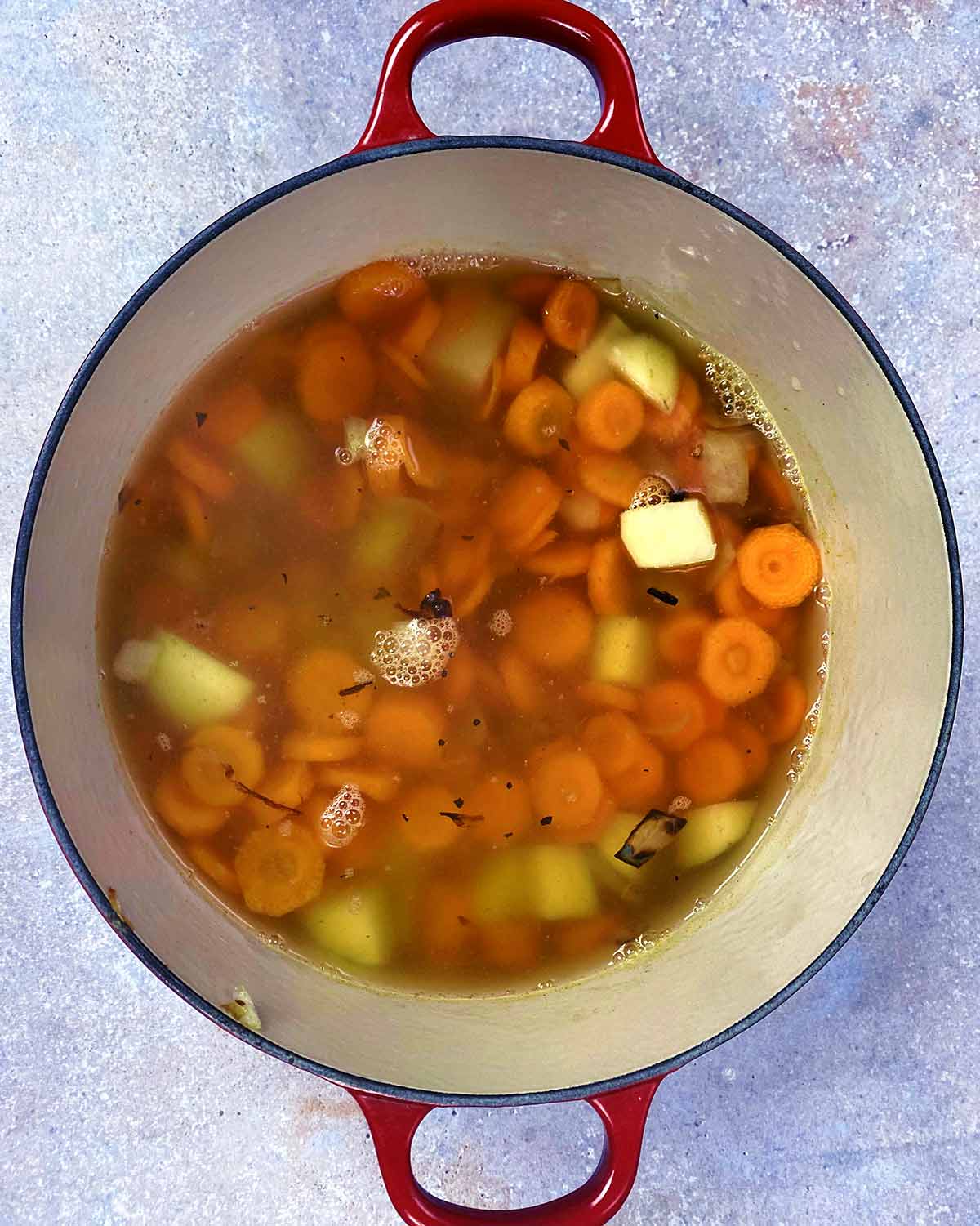 Stock and seasoning added to the pan.