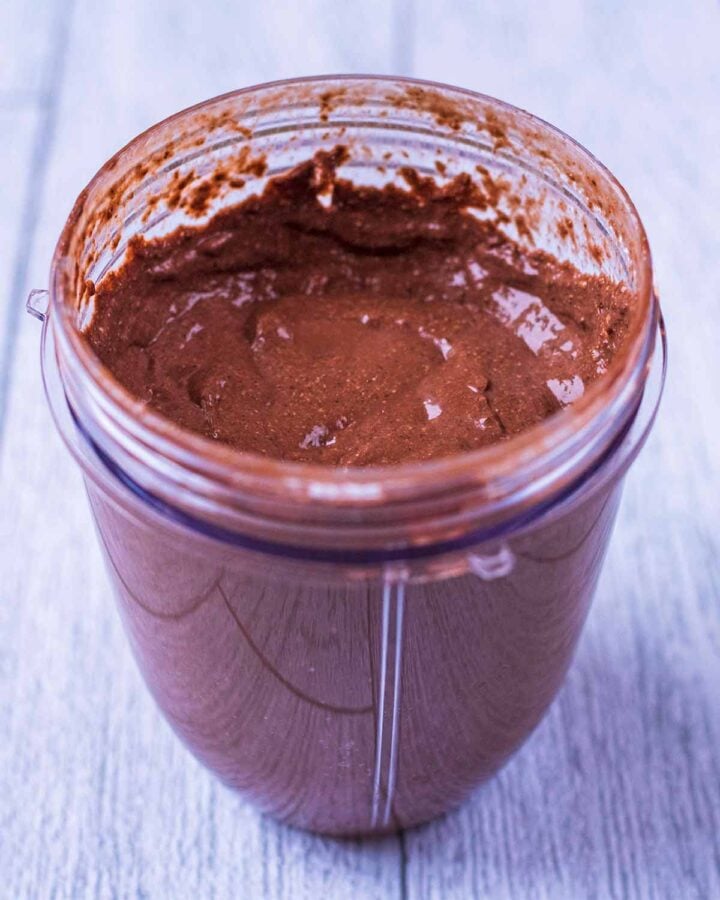 A blender jug full of blended chocolate pudding.