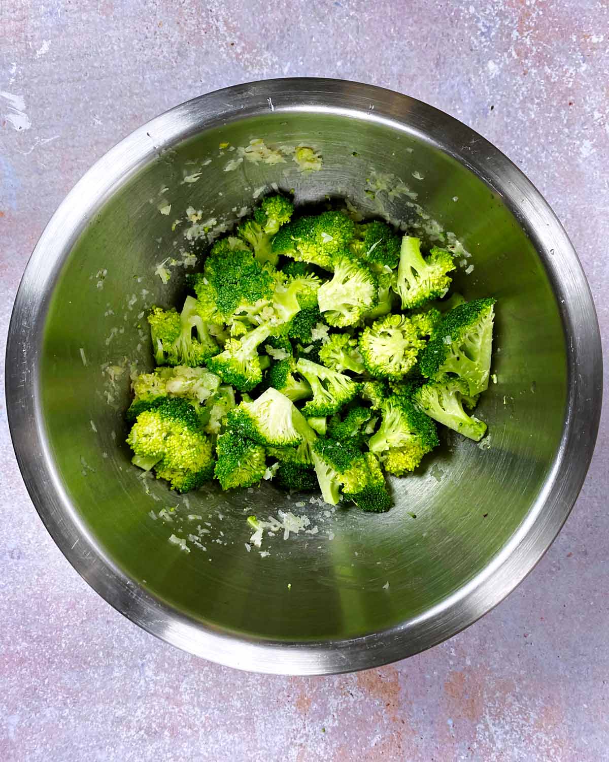Broccoli mixed into the garlic and Parmesan mixture.