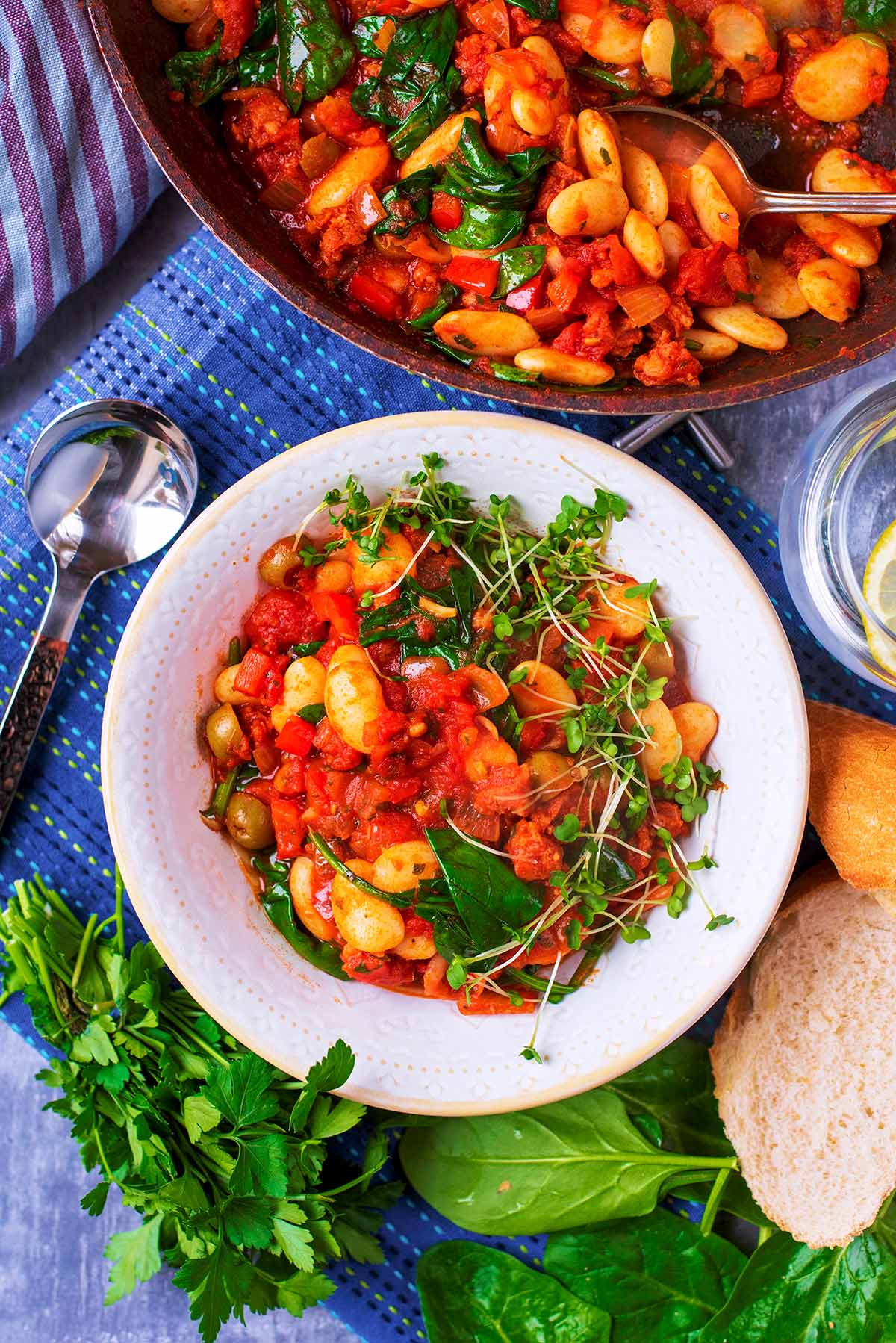 Bean Stew in a white bowl next to a pan of more stew.