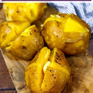 Four slow cooker jacket potatoes on a wooden board with a text title overlay.