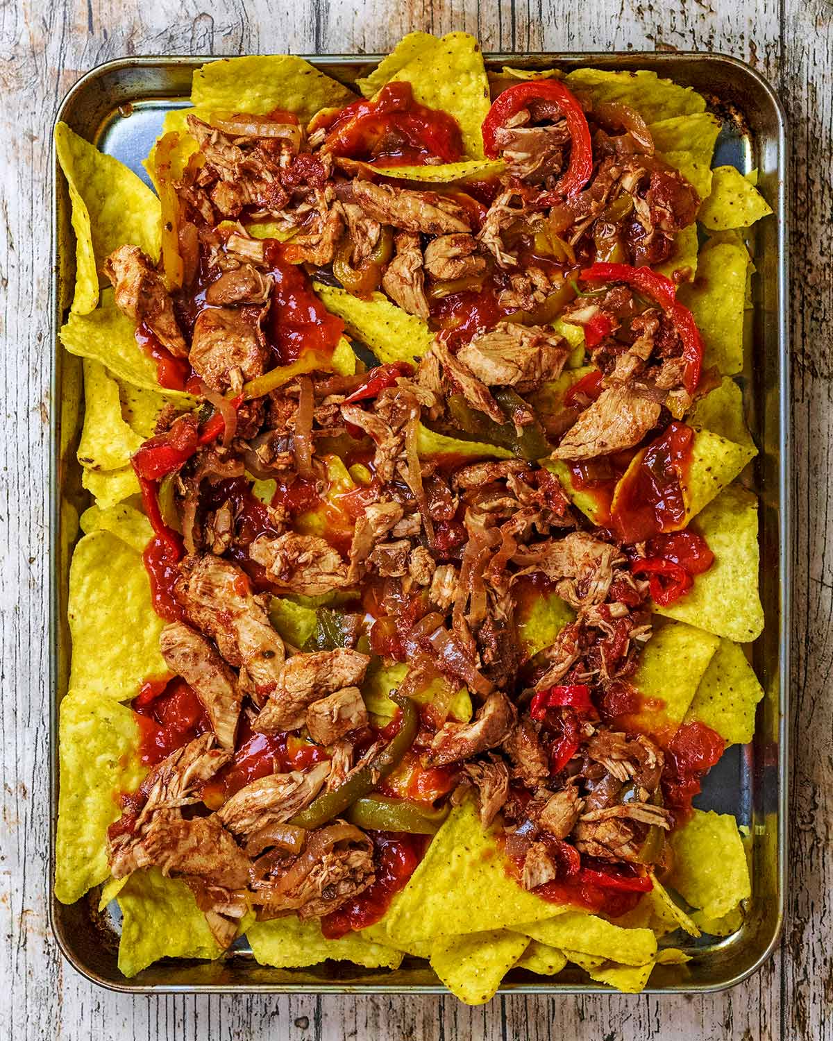 Chicken fajita mix added to tortilla chips and salsa.