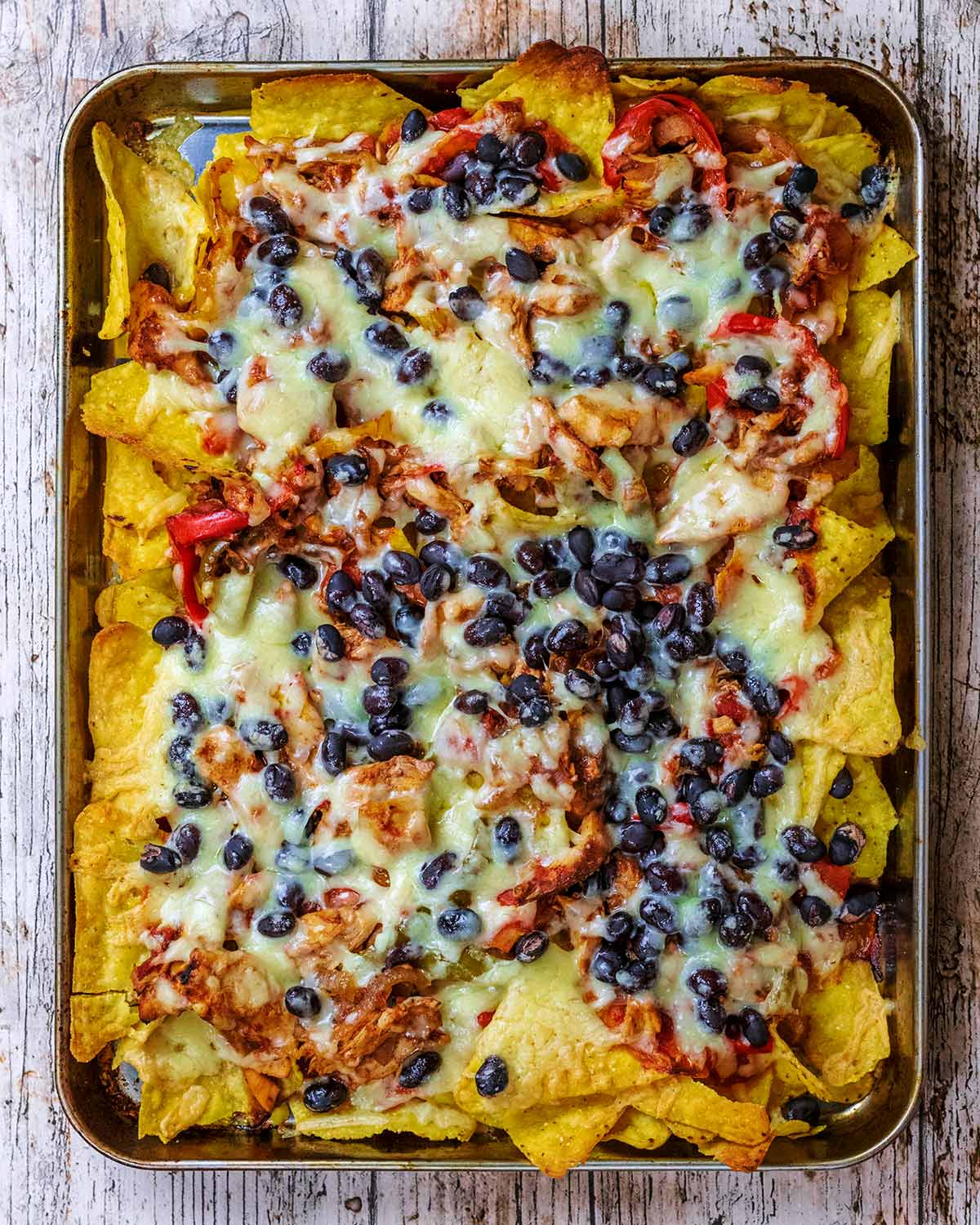 Baked nachos covered in melted cheese.