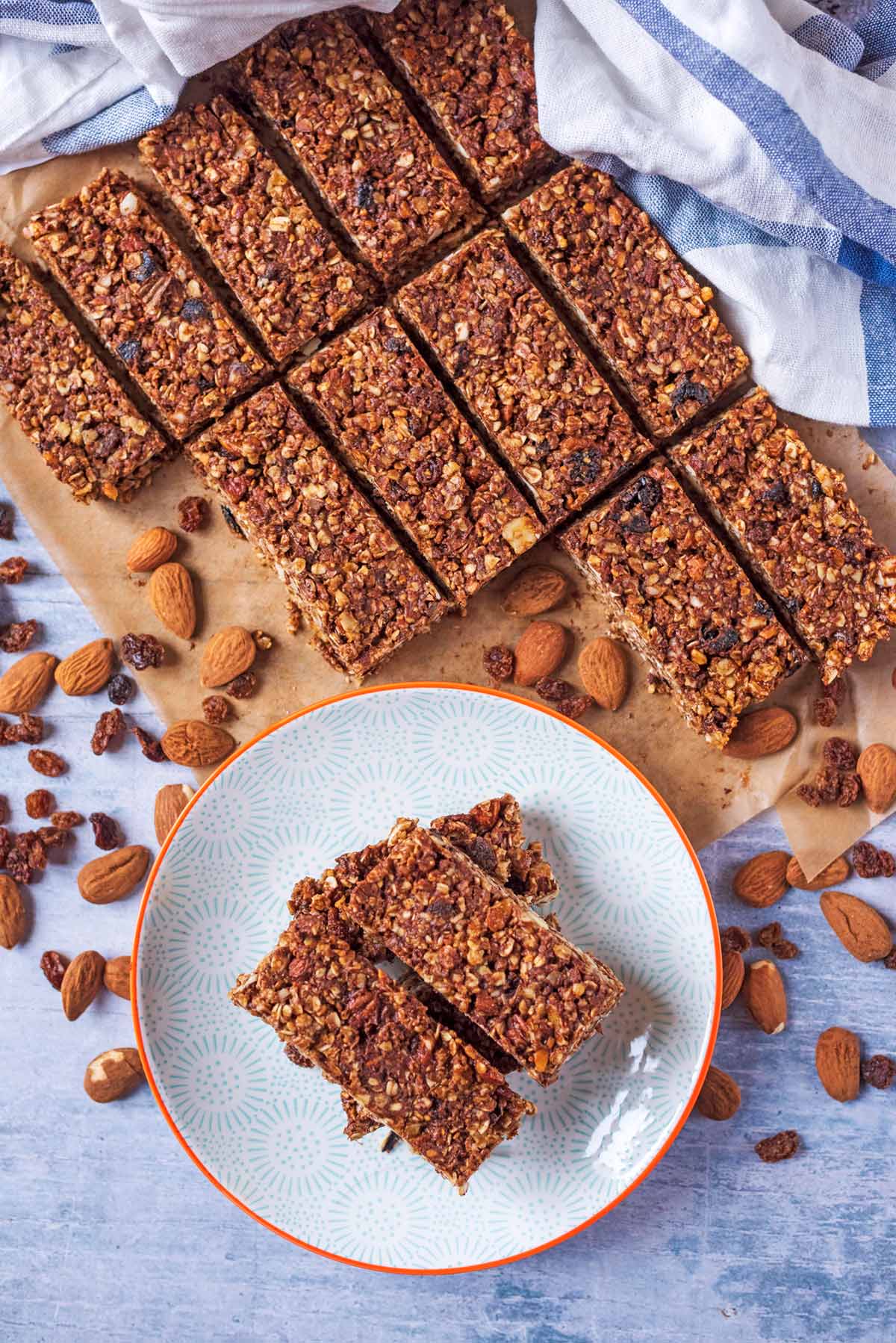 Rows of granola bars next to a plate with more bars on it.