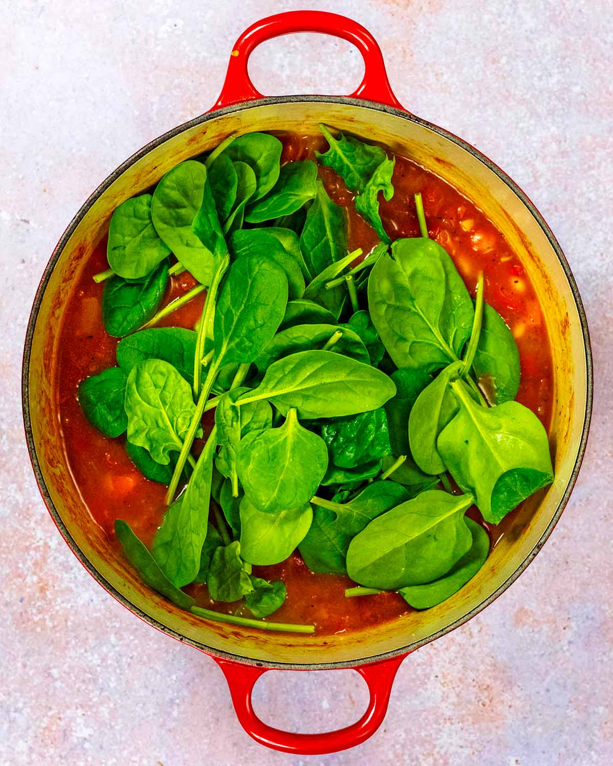 Fresh spinach added to the pan.