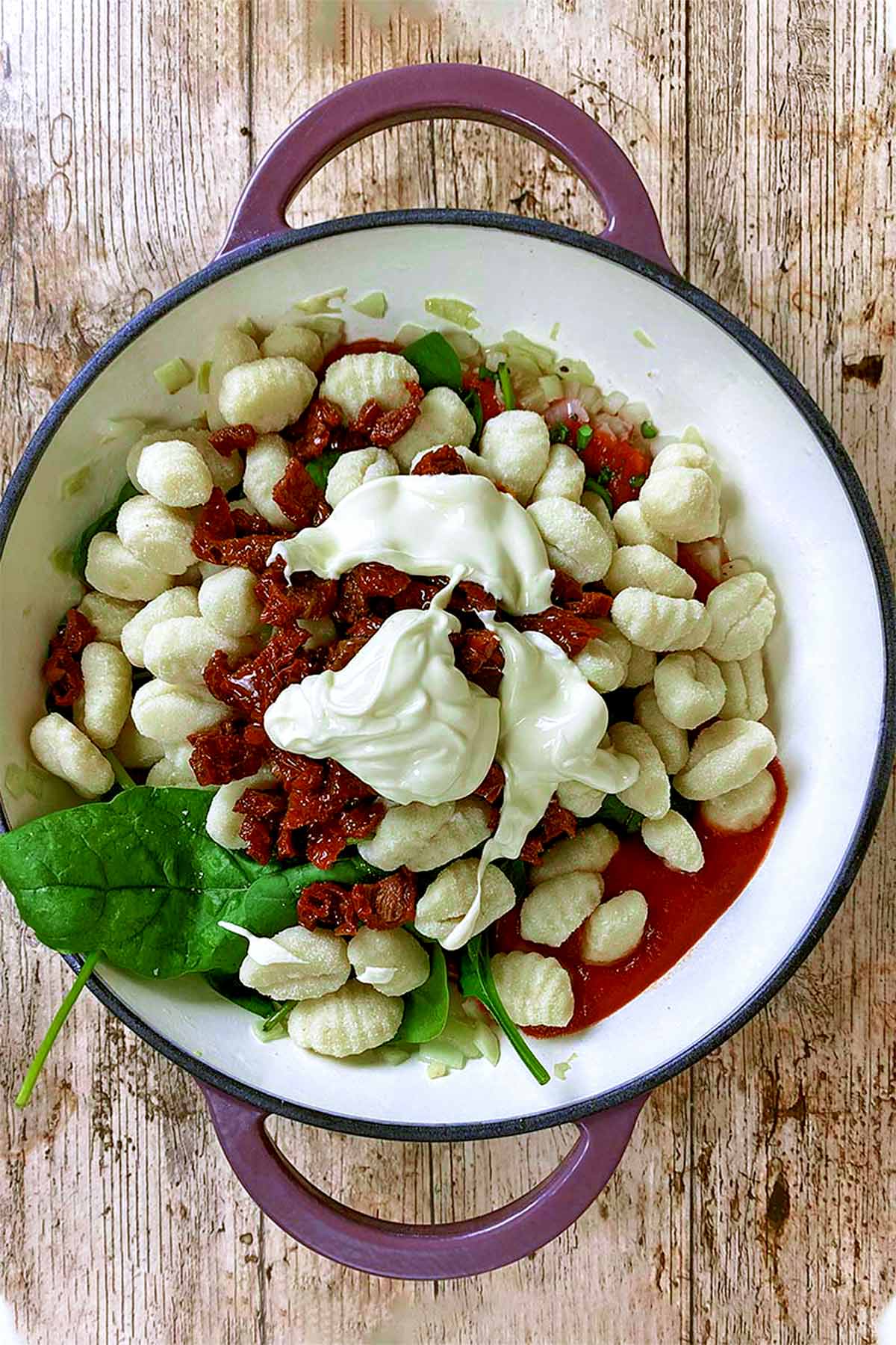 Gnocchi, passata, spinach, tomatoes and cream added to the pan.