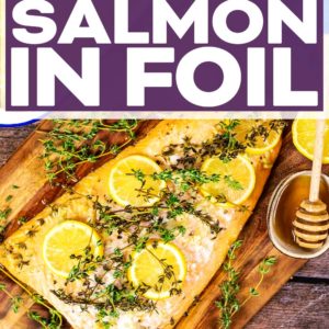 Baked salmon in foil on a wooden serving board with a text title overlay.