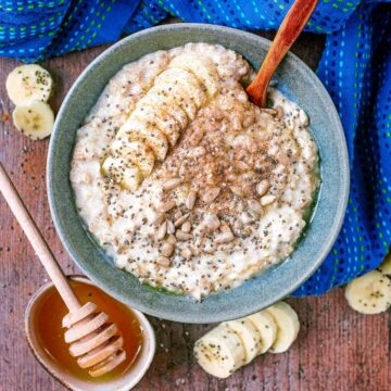 Banana Porridge in a bowl with a small wooden spoon.