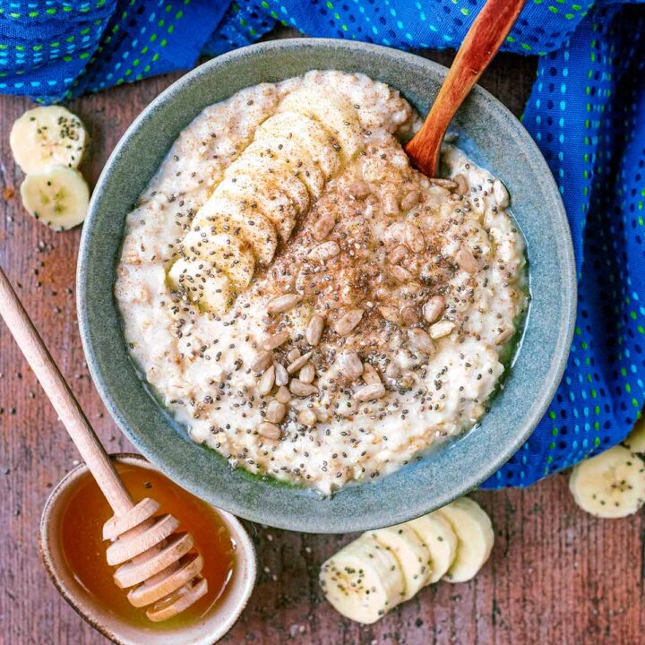 Banana Porridge in a bowl with a small wooden spoon.