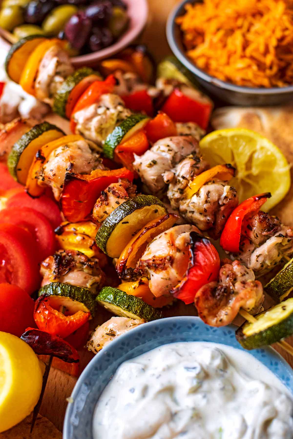 Chunks of cooked chicken and sliced vegetables together on skewers.