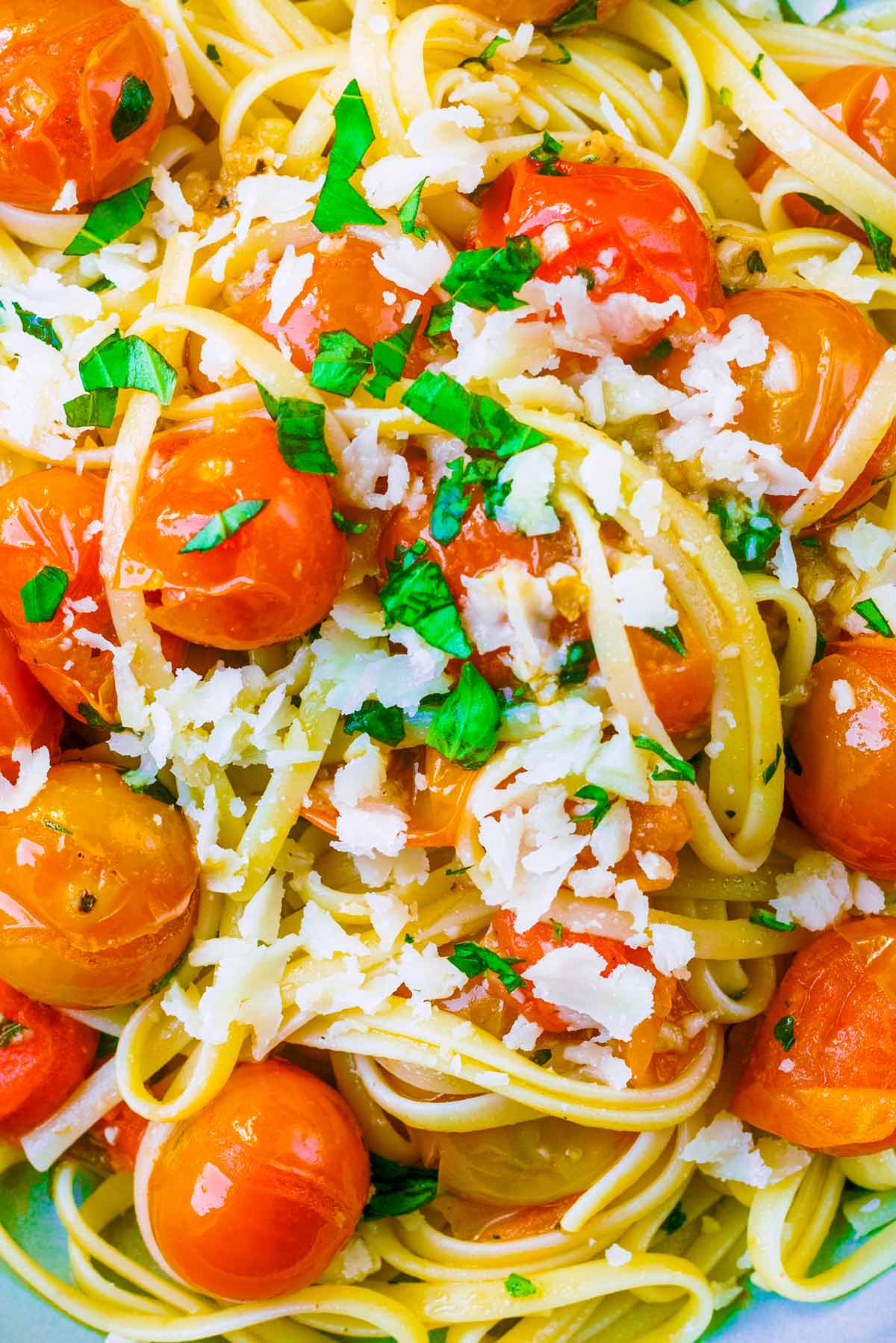 Cherry tomatoes mixed with linguine, chopped basil and shavings of Parmesan.