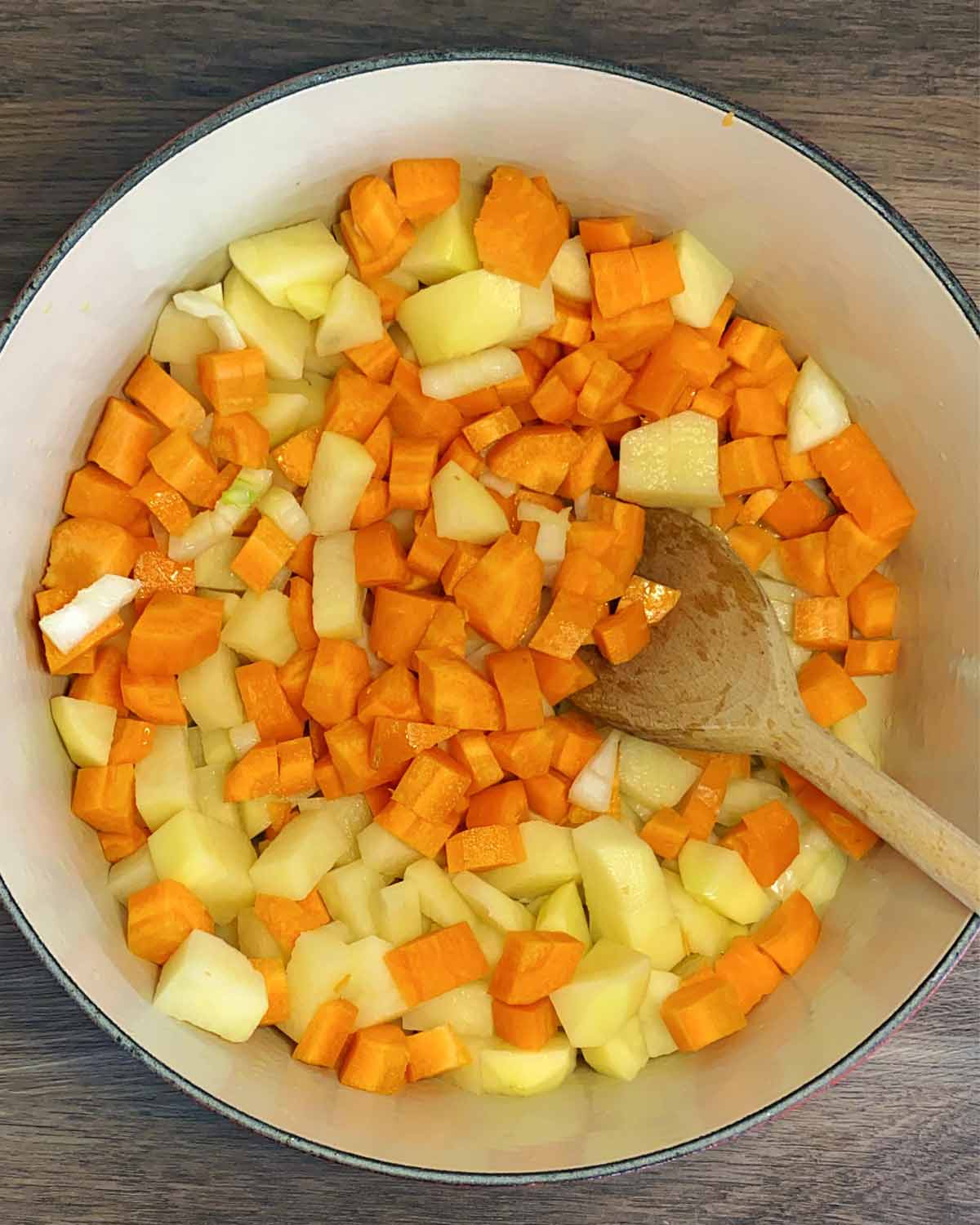 Chopped carrot and chopped potato added to the pan.