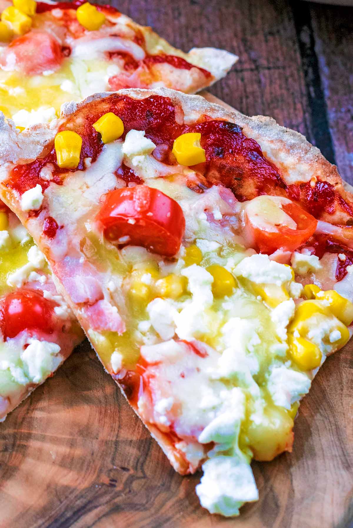 A slice of pizza topped with vegetables and cheese.